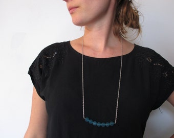 Long necklace with blue/green glass beads and silver chain
