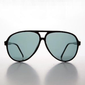 May include: Black aviator sunglasses with dark gray lenses. The sunglasses have a classic design with a thin frame.