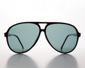 May include: Black aviator sunglasses with dark gray lenses. The sunglasses have a classic design with a thin frame.