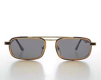 May include: Rectangular sunglasses featuring a thin gold metal frame with a double bridge design. The rims are accented with a dark brown tortoiseshell pattern, and the lenses are a solid dark grey tint, providing a classic and structured look.