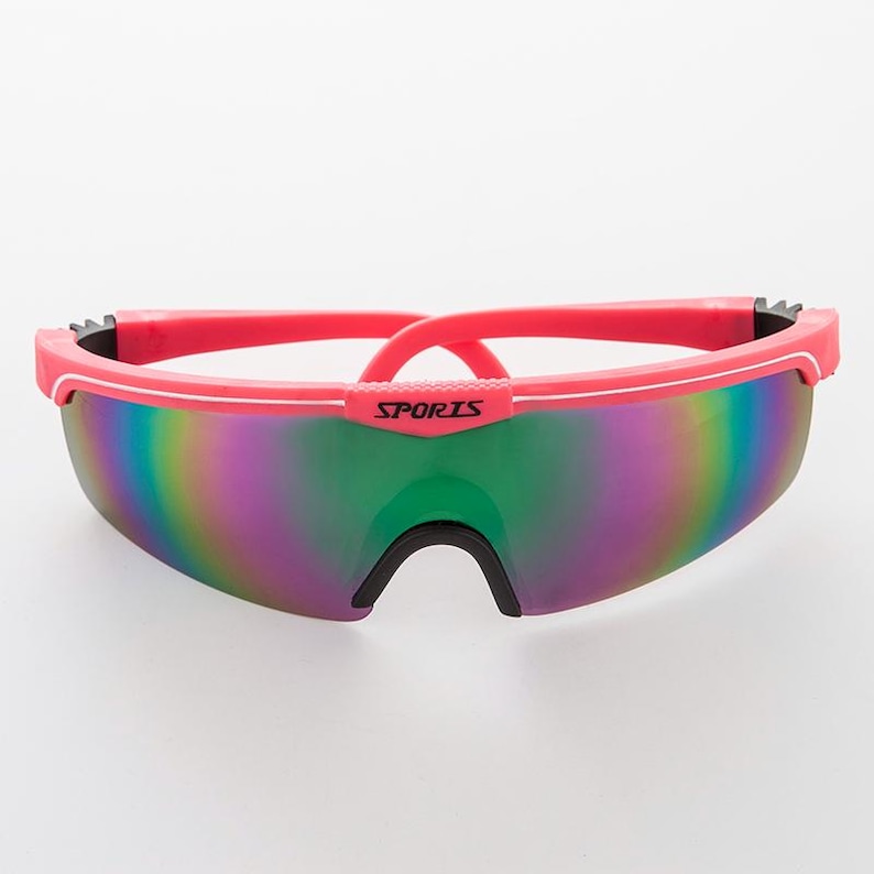May include: Pink and black sports sunglasses with iridescent lenses and the word "SPORTS" printed on the frame.