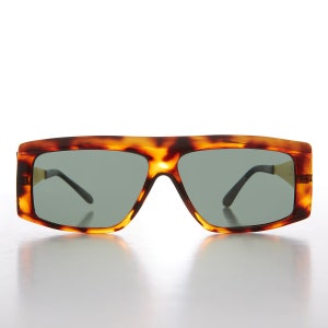 May include: Tortoise shell sunglasses with a rectangular frame and dark gray lenses.