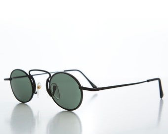May include: Black round sunglasses with thin metal frames and green lenses.
