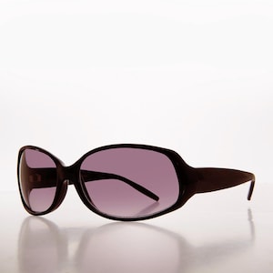 Puede incluir: Gafas de sol marrón oscuro con montura ovalada grande y lentes teñidas de púrpura. Las gafas de sol tienen un diseño elegante y moderno, adecuado para la protección solar.