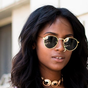 round gold classic sunglasses on model