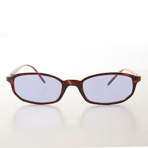 May include: Tortoise shell frame sunglasses with purple lenses.
