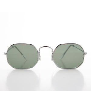 May include: Silver framed sunglasses with green lenses and a geometric octagonal shape.