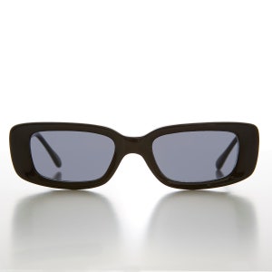 May include: Black rectangular sunglasses with dark lenses.