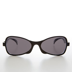 May include: Black sunglasses with a rounded, oval shape. The sunglasses have a dark gray lens and a black frame.