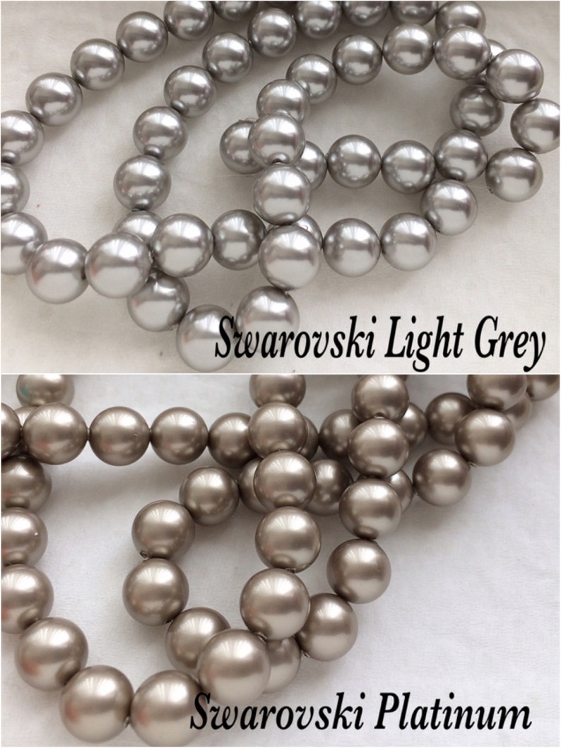 May include: Two strands of round, pearl-like beads. The top strand is light gray and labeled "Swarovski Light Grey". The bottom strand is a darker, silvery gray and labeled "Swarovski Platinum".