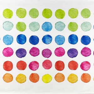May include: A white rectangular textile featuring a pattern of watercolor polka dots. The dots are arranged in rows and columns, with each row displaying a different color, including green, blue, pink, and yellow.