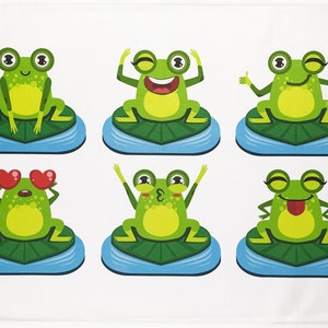 May include: A white cloth featuring six cartoon frogs in various poses. Each frog is green with yellow bellies, sitting on a green lily pad surrounded by blue water. The frogs display different expressions, including winking, thumbs up, and hearts for eyes.