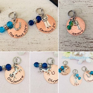 May include: Five copper dog tags with different charms and text. The tags are decorated with blue and green beads. The text on the tags includes "Fine Tuned GSF", "Commando 2", "Jersey", "Cheyenne", "Harvey", "Cheye", "TE", and "Radar".