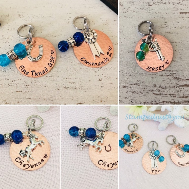 May include: Five copper dog tags with different charms and text. The tags are decorated with blue and green beads. The text on the tags includes "Fine Tuned GSF", "Commando 2", "Jersey", "Cheyenne", "Harvey", "Cheye", "TE", and "Radar".
