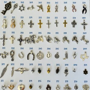 Pu&ograve; includere: Una collezione di 30 ciondoli in argento, tra cui una chiave, una stella di David, una colomba, un uccello, un nastro, una croce, un unicorno, un ferro di cavallo, una piuma, un'ala, una ghianda, una pigna, una rosa, una corona, un cuore, un'impronta di zampa, una luna crescente e un cuore con il testo "Miglior amico".