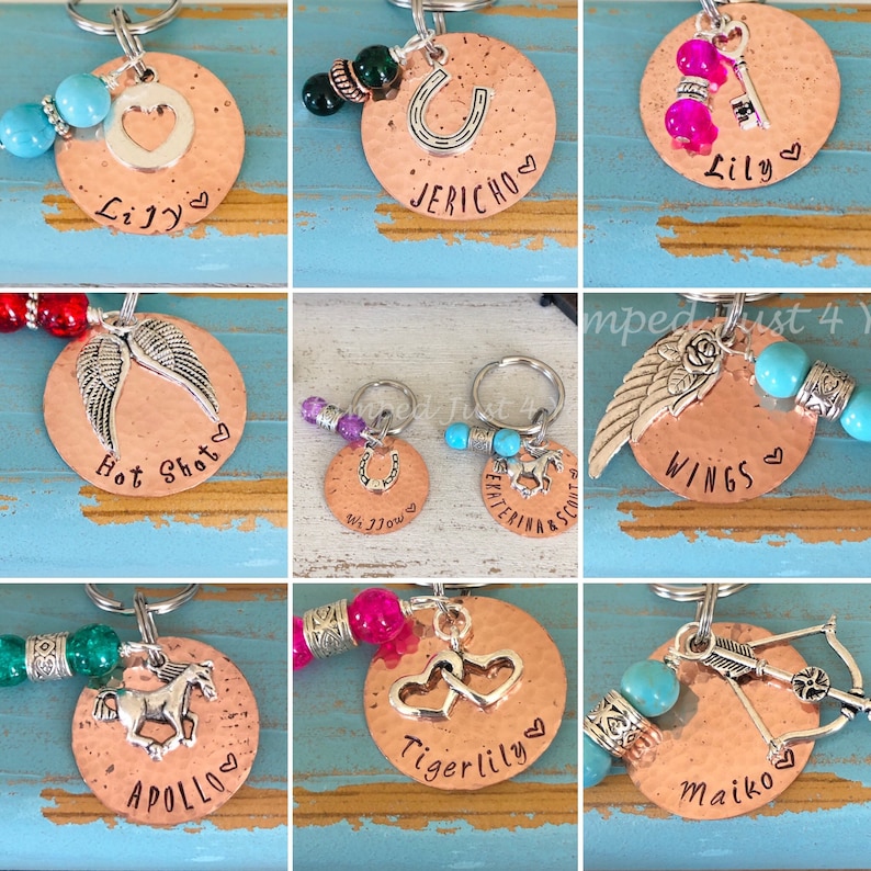 May include: Nine copper keychains with different charms and personalized names. The charms include a horseshoe, a heart, wings, a horse, and an arrow. The names on the keychains are Lily, Jericho, Hot Shot, Wings, Apollo, Tigerlily, and Maiko.