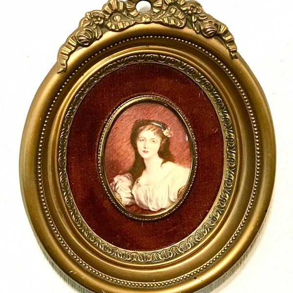 A Cameo Creation of Nobility Cecile Volage by J B Greuze with Convex Glass Deep Red Velour Surrounded in Gold.  9” x 7” Framed