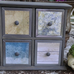 Small gray furniture with 4 wooden drawers for jewelry or souvenirs, romantic countryside spirit