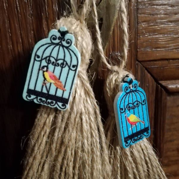 Petits pompons de porte cage à oiseaux