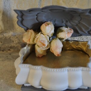 Jewelry box in gray patinated metal and recapitoned with a romantic style golden fabric.
