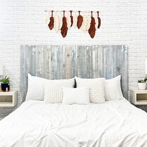Floating wood panel headboard full size stained with a blue tint, colorwashed with white chalk paint. Paired with minimalist wooden floating nightstands in an antique white color.