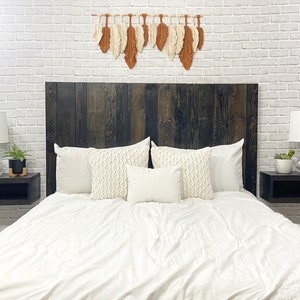 Floating wood panel headboard full size stained with a modern rustic black oil-based finish. Paired with minimalist wooden floating nightstands in a black wood stain finish.