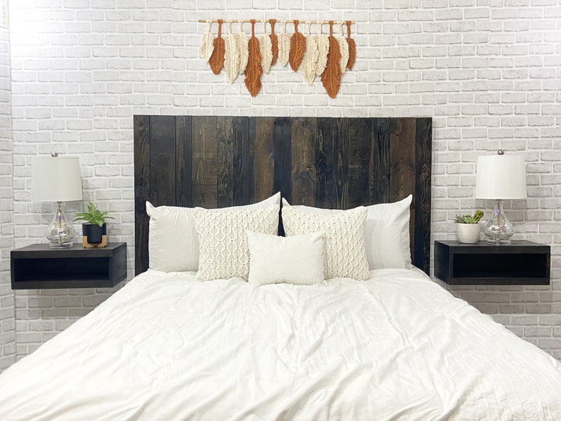 Floating wood panel headboard full size stained with a modern rustic black oil-based finish. Paired with minimalist wooden floating nightstands in a black wood stain finish.