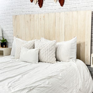 King-sized panel wood headboard, crafted from solid pine boards, showcases beautiful wood grain patterns accentuated by an antique white tint. This farmhouse white headboard is compatible with Sleep Number beds.