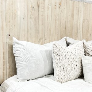 California King size headboard compatible with adjustable bed. Made with vertical wooden pallet boards, tinted with an antique white chalk paint. Farmhouse and Cottage home decor style.