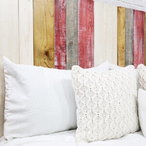King size panel wood headboard for sleep number beds made with multi colored wood planks in red-wash, gray-wash, antique white weathered and distressed, and a golden brown wood stain exposing the beautiful wood grain patterns from the solid wood.
