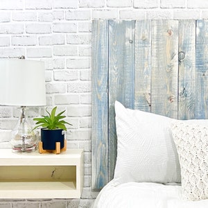 King-sized panel wood headboard, crafted from solid pine boards, showcases beautiful wood grain patterns accentuated by a blue and white hues. This farmhouse blue headboard is compatible with Sleep Number beds.