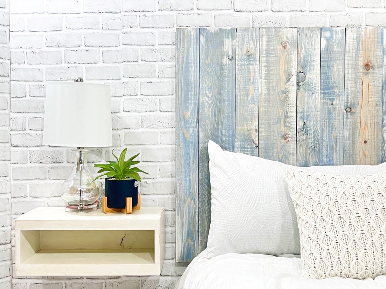 King-sized panel wood headboard, crafted from solid pine boards, showcases beautiful wood grain patterns accentuated by a blue and white hues. This farmhouse blue headboard is compatible with Sleep Number beds.