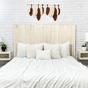 Floating wood panel headboard full size painted with chalk paint in an antique white farmhouse color, weathered and distressed. Paired with minimalist wooden floating nightstands in an antique white color.