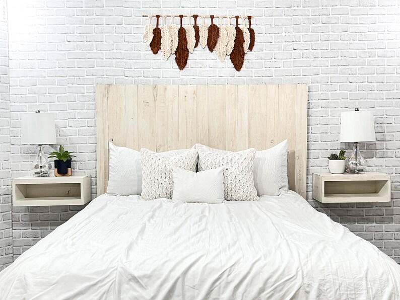 Floating wood panel headboard full size painted with chalk paint in an antique white farmhouse color, weathered and distressed. Paired with minimalist wooden floating nightstands in an antique white color.