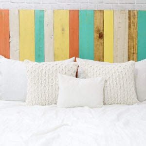 California King size headboard compatible with adjustable bed. Made of multi-colored vertical wooden pallet boards in brown, coral, white, yellow and green colors, in a boho chic, eclectic, earth tone, hipster, hippie, home decor style.