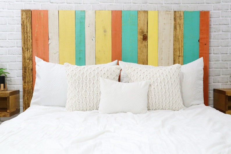 California King size headboard compatible with adjustable bed. Made of multi-colored vertical wooden pallet boards in brown, coral, white, yellow and green colors, in a boho chic, eclectic, earth tone, hipster, hippie, home decor style.