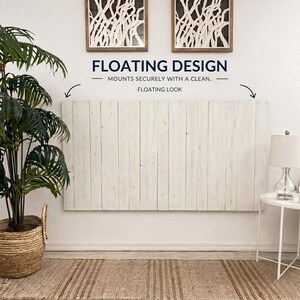 May include: A rectangular headboard constructed from vertical white-washed wooden planks. The text FLOATING DESIGN MOUNTS SECURELY WITH A CLEAN, FLOATING LOOK is printed above the headboard, accompanied by two curved arrows pointing downward.