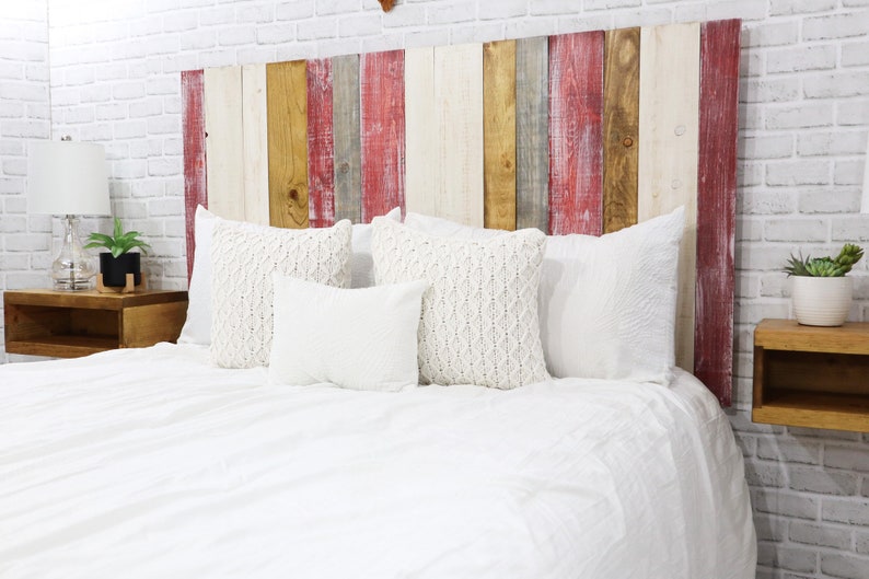 Full size multicolored wood panel floating headboard with antique white, redwash, graywash and golden brown stain finish, paired with matching floating nightstands in a golden brown wood stain.