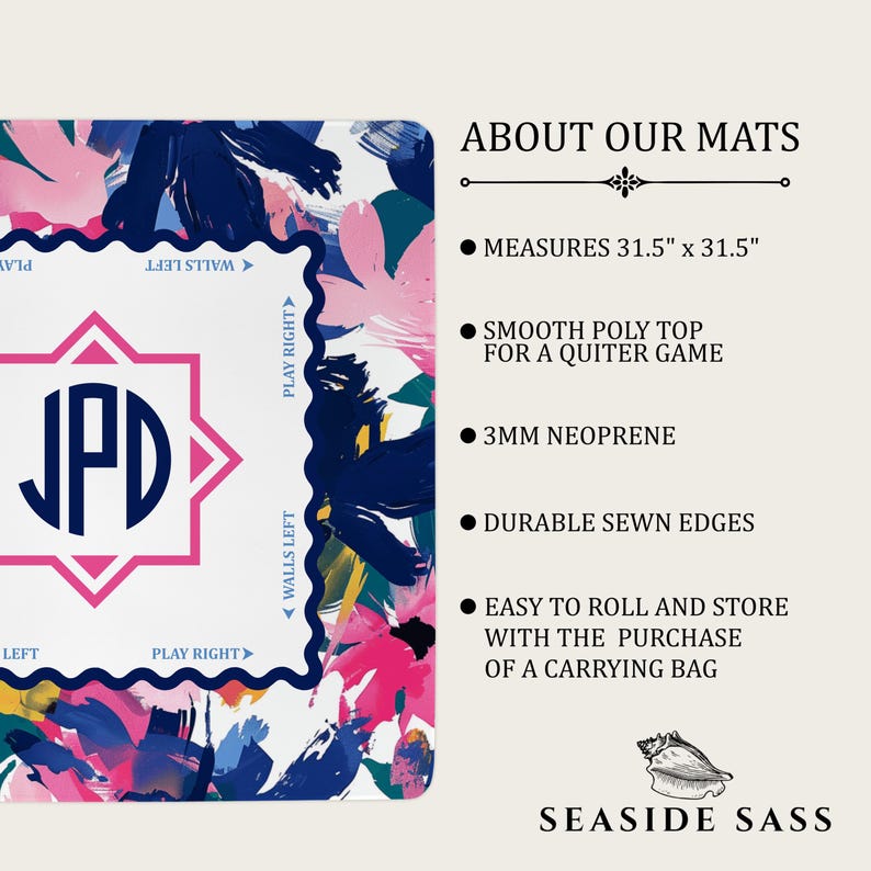 May include: A square game mat measuring 31.5 inches by 31.5 inches, featuring a white center with a navy blue JPD monogram inside a pink star. The border has a navy blue scalloped edge with text, surrounded by a colorful abstract floral pattern.
