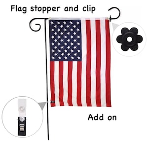 May include: A black metal flagpole with a flag clip and a flower-shaped flag stopper. The flagpole is holding an American flag. The text "Add on" is written below the flag.