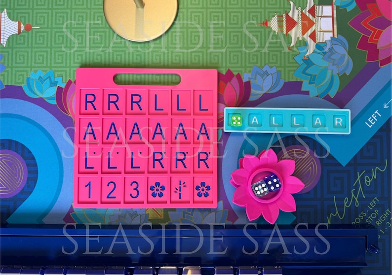 May include: A pink Scrabble tile holder with blue letter tiles, a blue tile holder with the word "ALLAR", a pink flower with a die, and a background with floral and geometric patterns. The text "SEASIDE SASS" is visible.