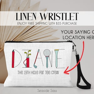 May include: White linen wristlet with a black zipper and a black wrist strap. The wristlet has a golf-themed design with the word "DIANE" spelled out using golf clubs, a golf ball, and a pencil. The text "THE 19TH HOLE par tee crew" is printed below the design.