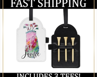 May include: White leather golf bag luggage tag with a colorful watercolor design of a golf bag and clubs. The tag has the name "Jamie" written on it. The tag is attached to a black leather golf tee holder with three golf tees.