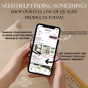 May include: A mobile phone screen displaying a shop's homepage with the name "Seaside Sass" and a variety of products for sale, including sports towels, tennis gifts, and linen wraps. The text "Browse by section" is visible on the screen. The phone is being held by a person's hands.