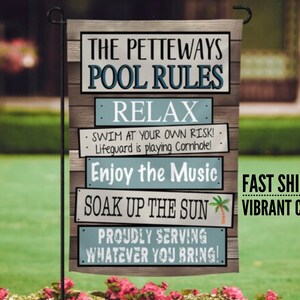 May include: A blue and white garden flag with the text "The Petteways Pool Rules" and a list of rules including "Relax", "Swim at your own risk! Lifeguard is playing Cornhole!", "Enjoy the Music", "Soak up the Sun", and "Proudly serving whatever you bring!"