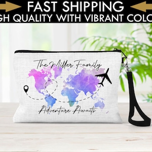 May include: White canvas zippered pouch with a black zipper and a black strap. The pouch features a watercolor world map with a pink, purple, and blue color scheme. The text "The Miller Family Adventure Awaits" is printed on the pouch.