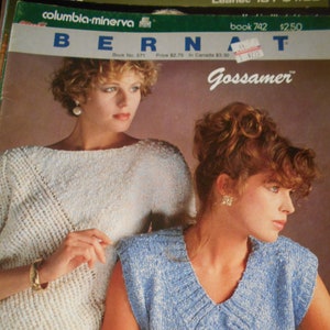 May include: Two women modeling knitted tops. The woman on the left is wearing a white top with a cable knit pattern. The woman on the right is wearing a blue top with a cable knit pattern. The text "Gossamer" is printed on the page.