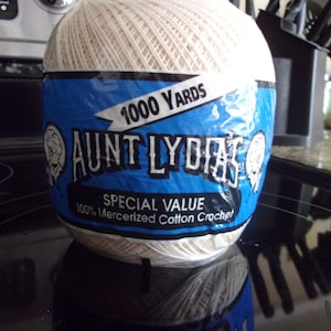 May include: A white ball of Aunt Lydia's 1000 yard special value 100% mercerized cotton crochet yarn.