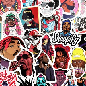 May include: A collection of colorful stickers featuring illustrations of hip-hop artists and related imagery. The stickers showcase various portraits, logos, and graphic designs, including the word "Compton" and the word "Snoopify".