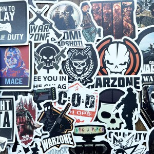 May include: A selection of Call of Duty themed stickers. The stickers display designs such as skulls, soldiers, and game-related text like "Warzone", "Born to Play", and "Mace". The stickers are in various shapes and sizes.